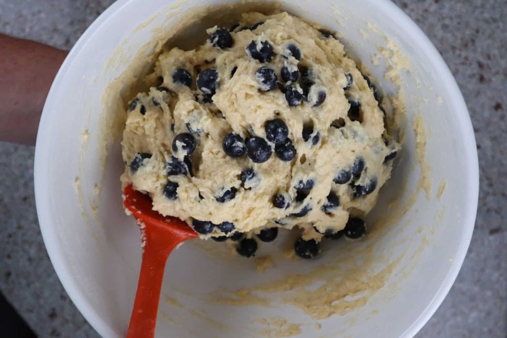 Folding in the blueberries into the muffin batter