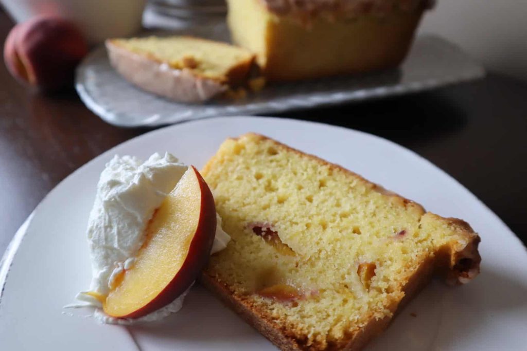 Close up of a slice of fresh peach pound cake recipe.