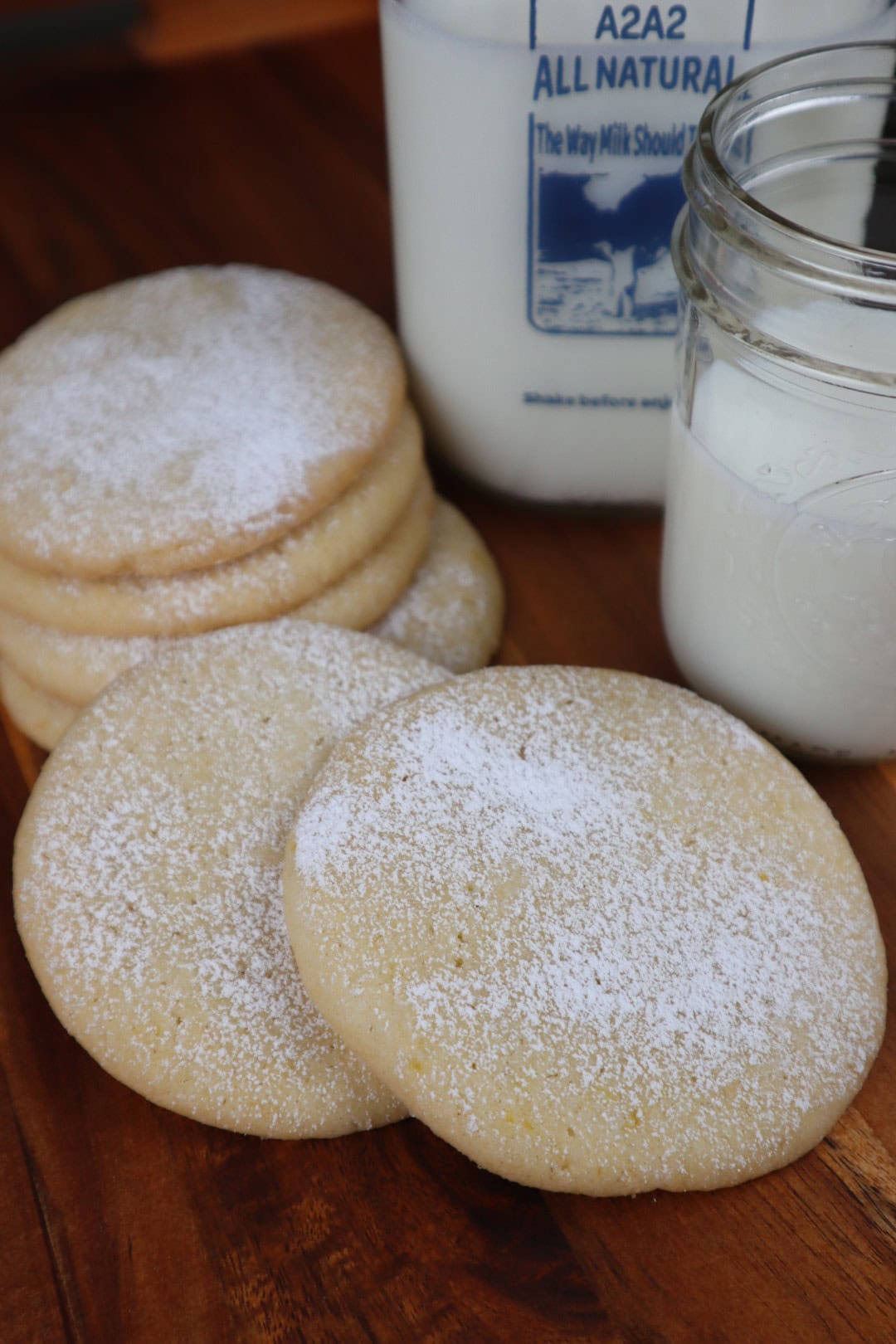 Lemon sugar cookies with a glass of milk.