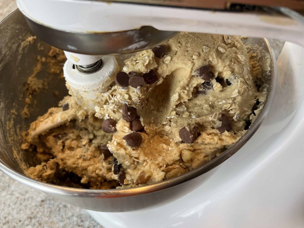 Mixer with the cookie dough for an oatmeal raisin chocolate chip cookie.