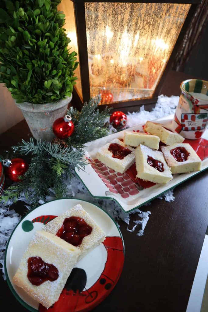 A plater of holiday squares in a Christmas setting. 