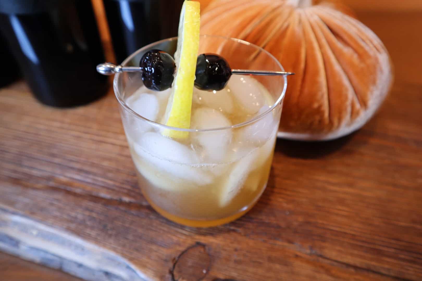 A Gold Rush cocktail with a lemon and cherry garnish