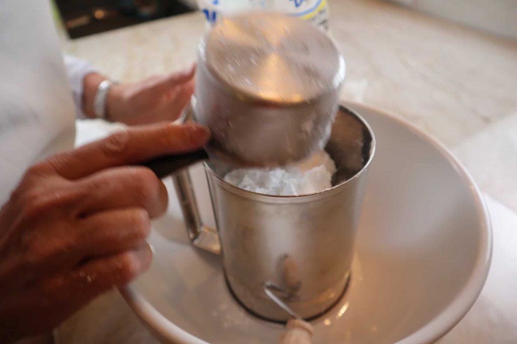 Sifting confectioners' sugar for the icing