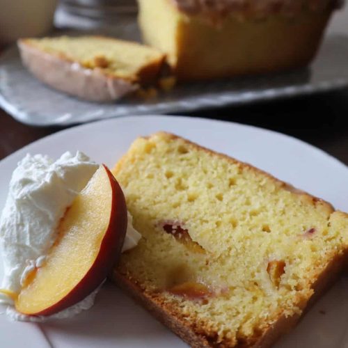 Close up of a slice of fresh peach pound cake recipe.