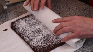 Rolling the chocolate peppermint roll cake.