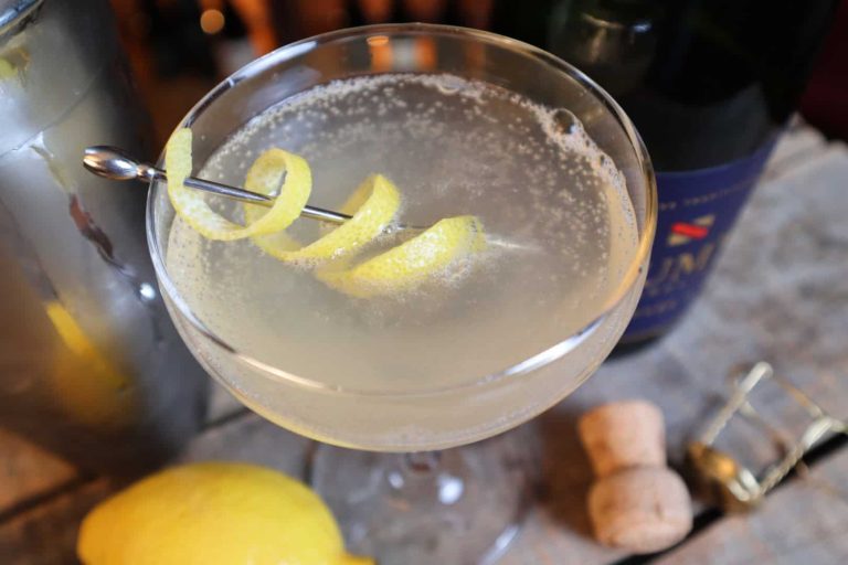 French 75 cocktail, romantic and sophisticated. Shown with a twist of lemon.